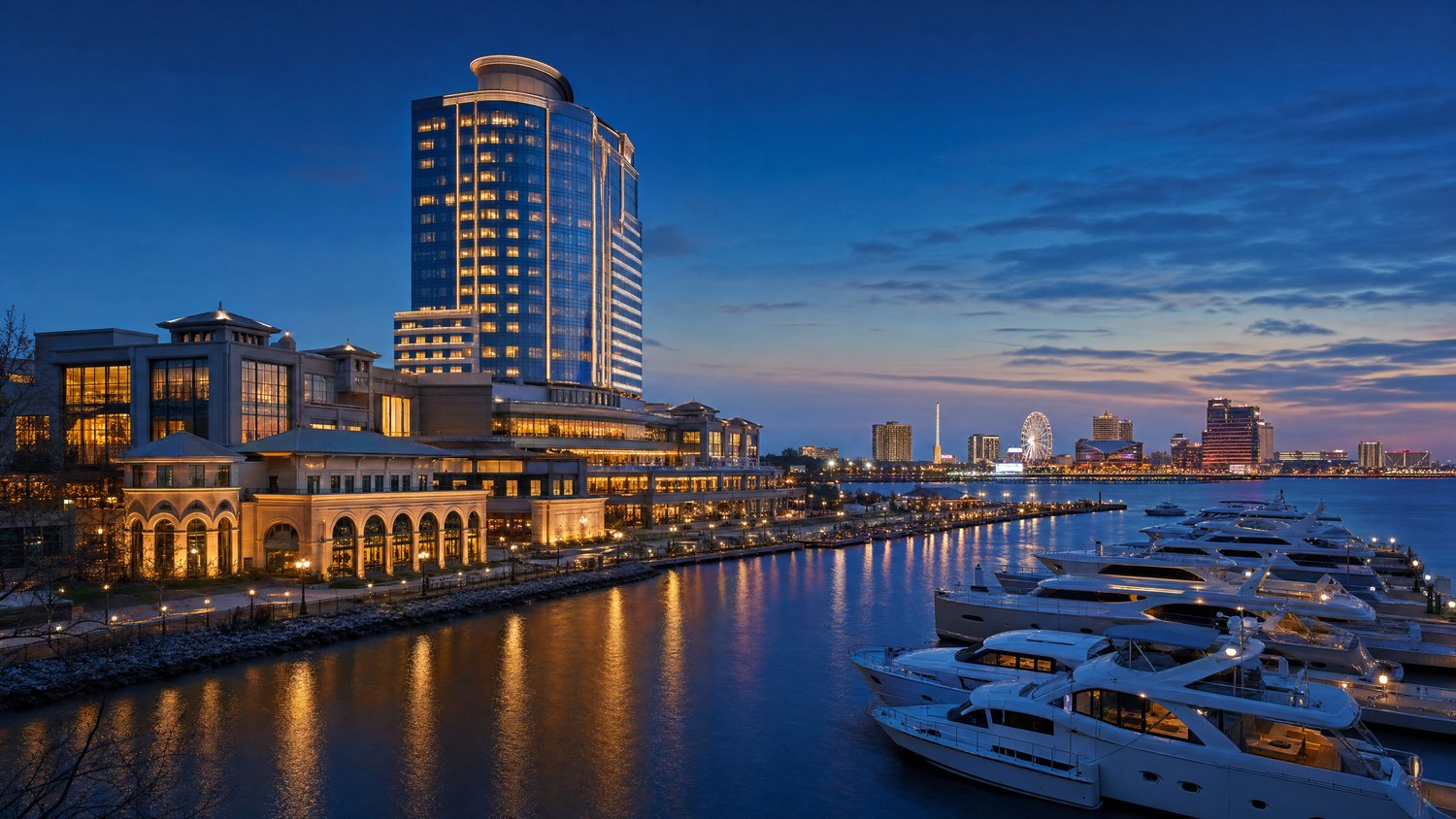 A refined waterfront resort tower and marina glowing at blue hour.